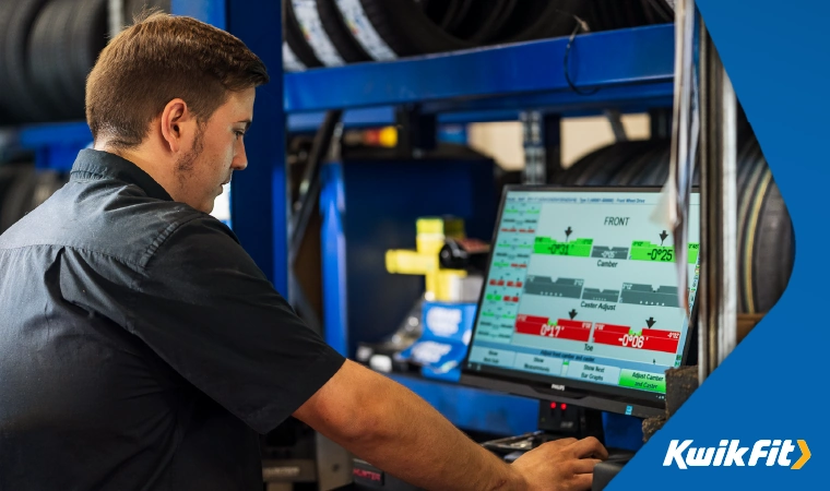 kwik fit technician using technology to report on a vehicle